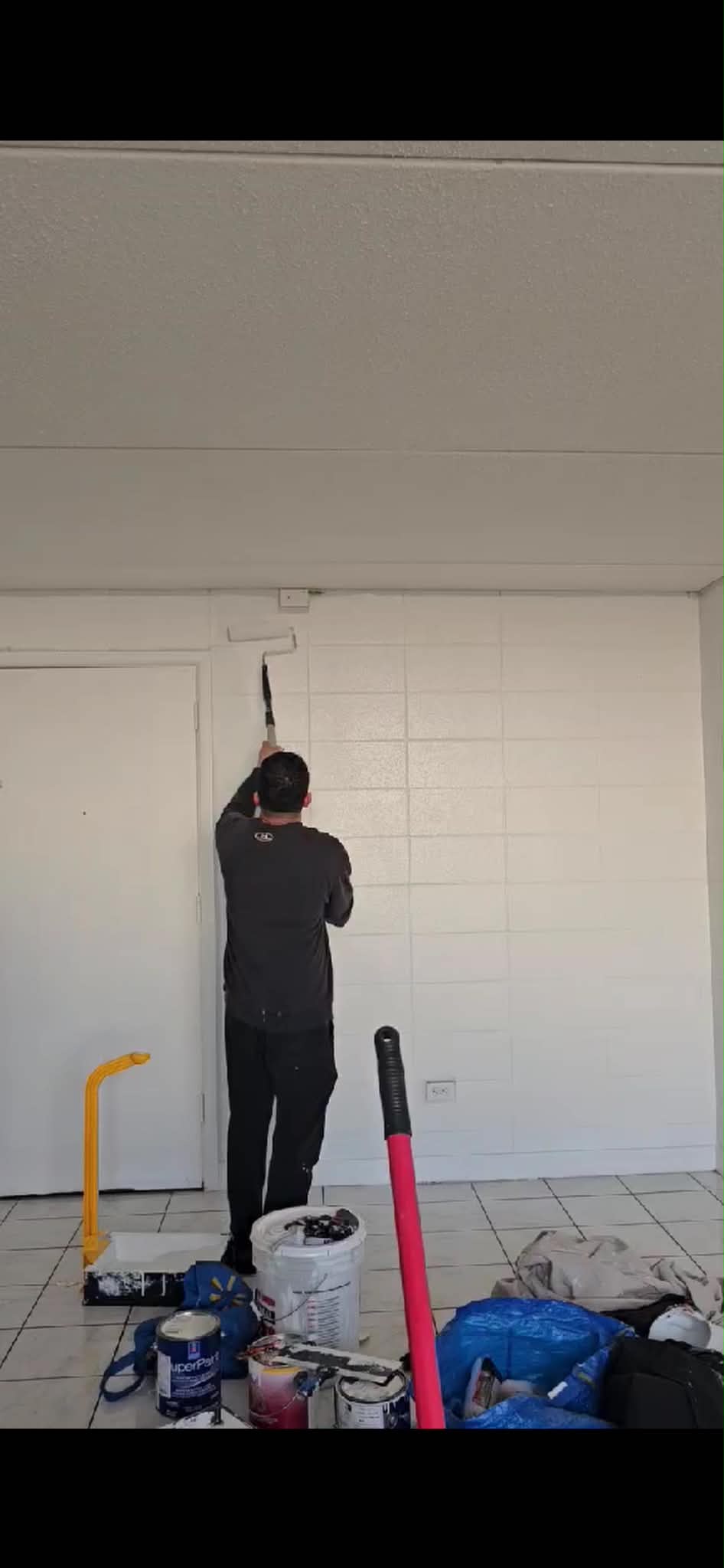 KMC professional painter using roller in Calgary